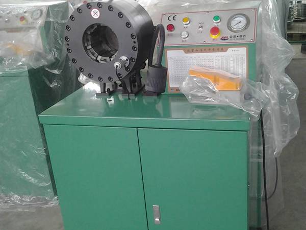 A green high pressure hose crimping machine (type C) is on the ground.