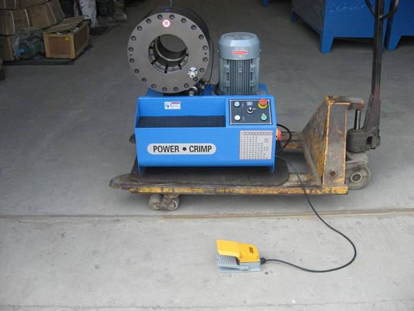 A set of vertical high pressure hydraulic hose crimping machine on the ground.